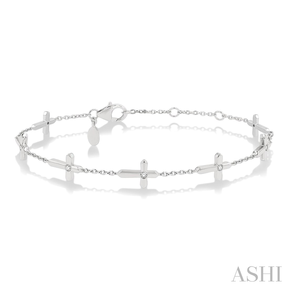 0.15 ctw Diamond Cross Charm Station 10K White Gold Bracelet: A vision of luxury, this elegant Cross Charm bracelet featuring Natural Diamonds defines sophistication. Expertly mounted in a Station setting, the bracelet is crafted in 2.85 grams of solid 10K White