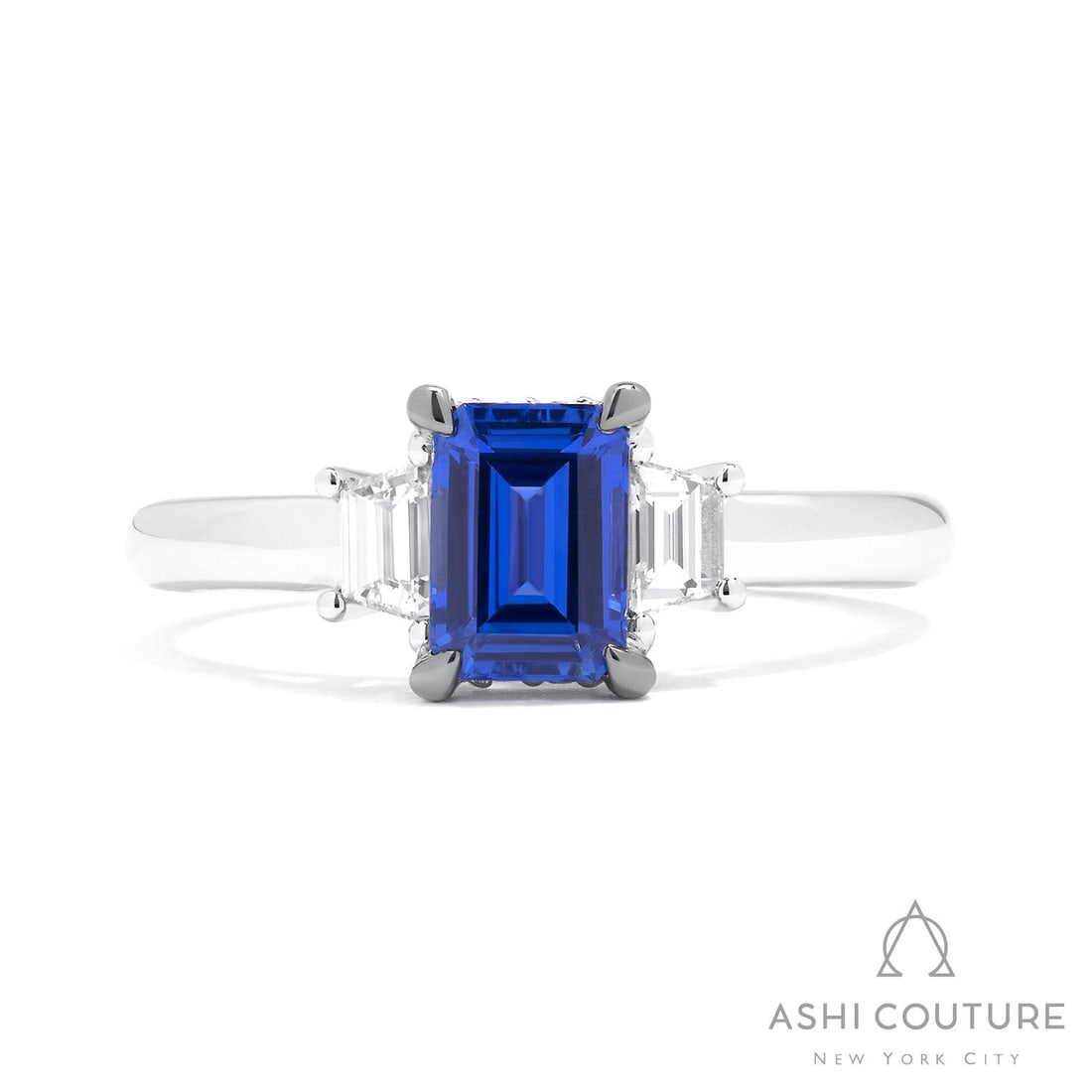 Emerald Cut Blue Sapphire and 0.36 ctw Diamond 18K White Gold Ring: Retail Value: $10,170 Rare and radiant, this magnificent Three-Stone ring featuring Blue Sapphire, White Diamond offers a touch of the extraordinary. Expertly mounted in a Three-Stone setting, the rin