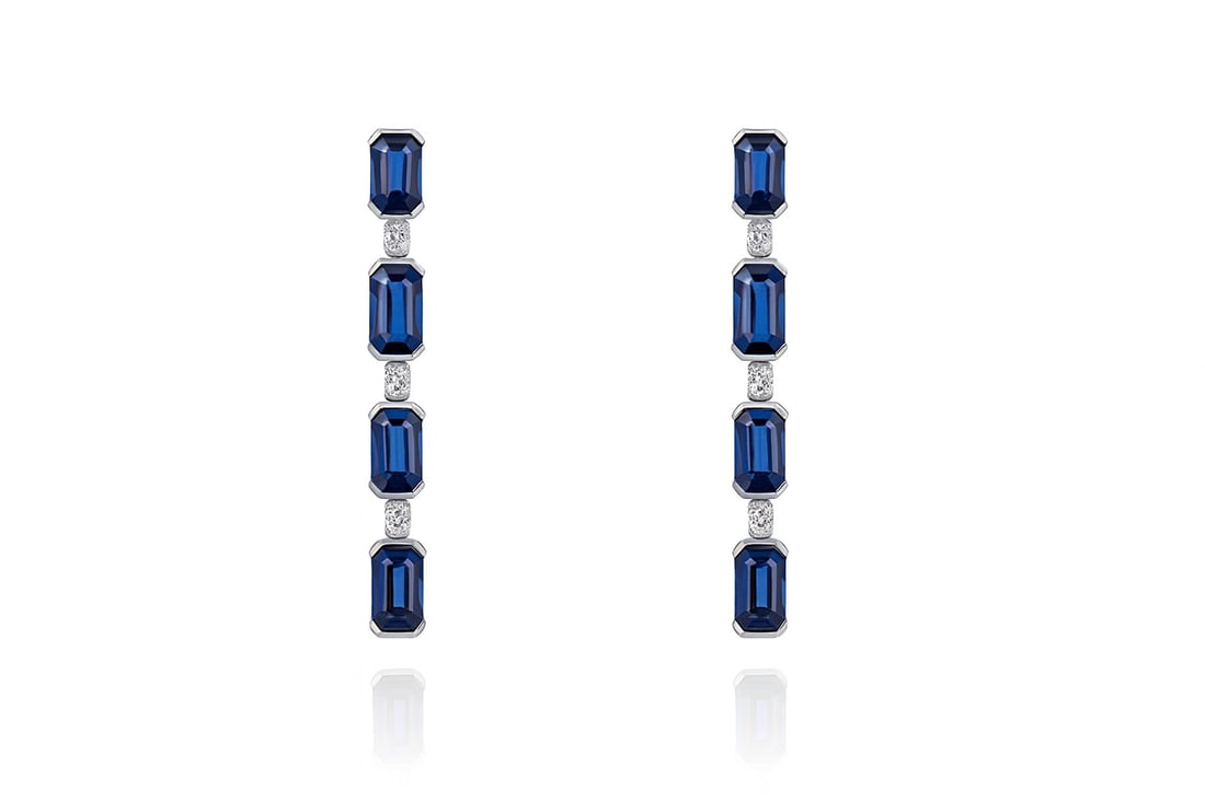 2.99ct Blue Sapphire and 0.12ctw Diamond 18K White Gold Earrings: Exuding opulence and grace, this magnificent Drop pair of earrings featuring Blue Sapphire, White Diamond is crafted for the distinguished. A detailed Drop gallery secures the stones, rendered in lust