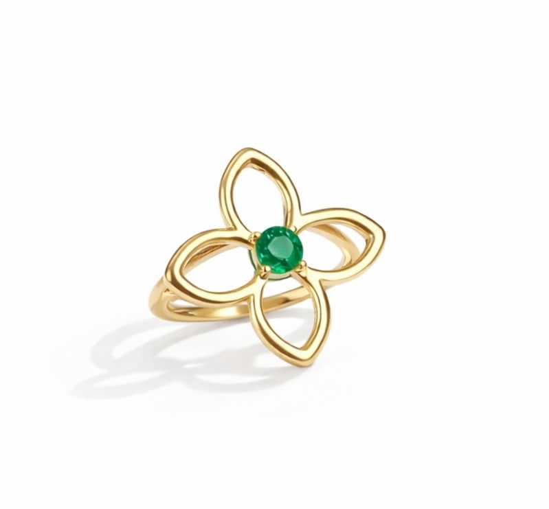0.23ctw Round Emerald 14K Yellow Gold Clover Ring: Defining modern elegance, this elegant Clover ring featuring Emerald captures the essence of style. The gemstones are nestled within a Bezel framework, supported by a substantial 3.6 grams 14K Yellow 