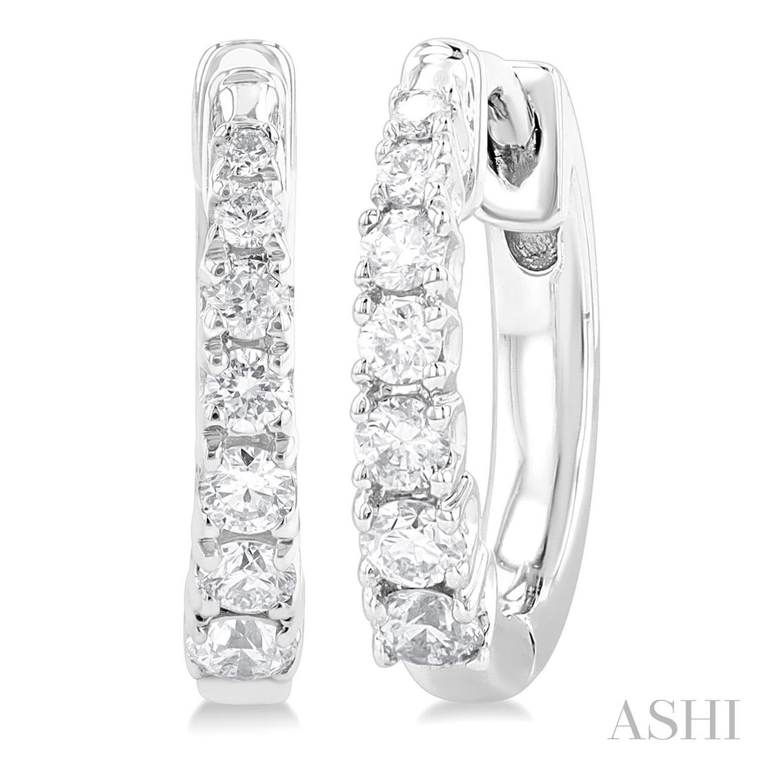 0.25 ctw Round Cut Diamond Graduated Huggie 10K White Gold Earrings: Captured in a moment of brilliance, this elegant Graduated pair of earrings featuring White Diamond speaks to the connoisseur. The gemstones are nestled within a Huggie framework, supported by a subst