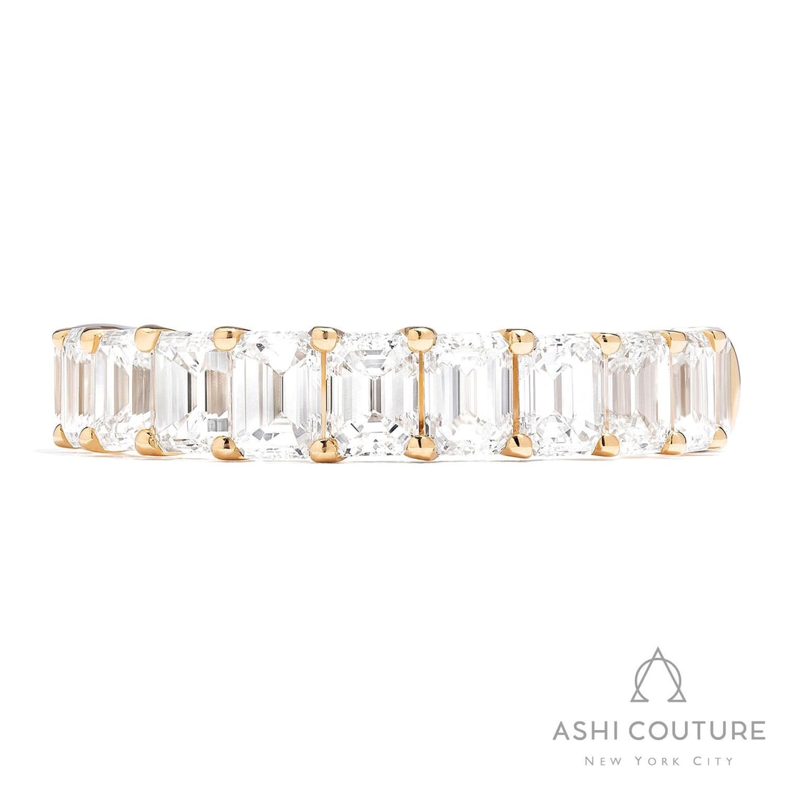 2.75 ctw Emerald Cut Diamond 18K Yellow Gold Band Ring: Retail Value: $20,145 Epitomizing grandeur, this magnificent Duchess Emerald Halfway Band ring featuring White Diamond stands as a beacon of refined taste. The gemstones are nestled within a Halfway B