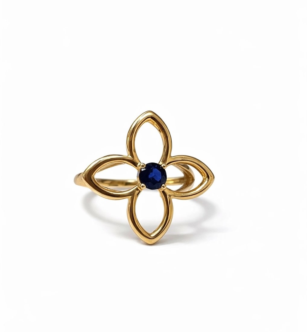 0.25ctw Blue Sapphire Clover 14K Yellow Gold Ring: Epitomizing grandeur, this exquisite Clover ring featuring Blue Sapphire stands as a beacon of refined taste. A detailed Bezel gallery secures the stones, rendered in 3.51 grams of lustrous 14K Yellow