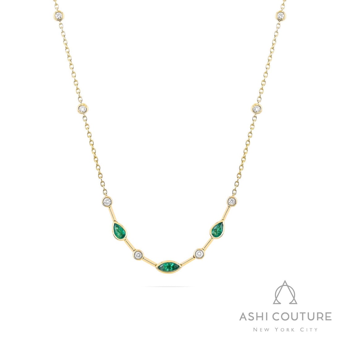 Emerald and 0.28 ctw Diamond 18K Yellow Gold Necklace: Defining modern elegance, this breathtaking Smile necklace featuring Emerald, White Diamond captures the essence of style. Securely held in a classic Bezel-Set Station Necklace design, the necklace is