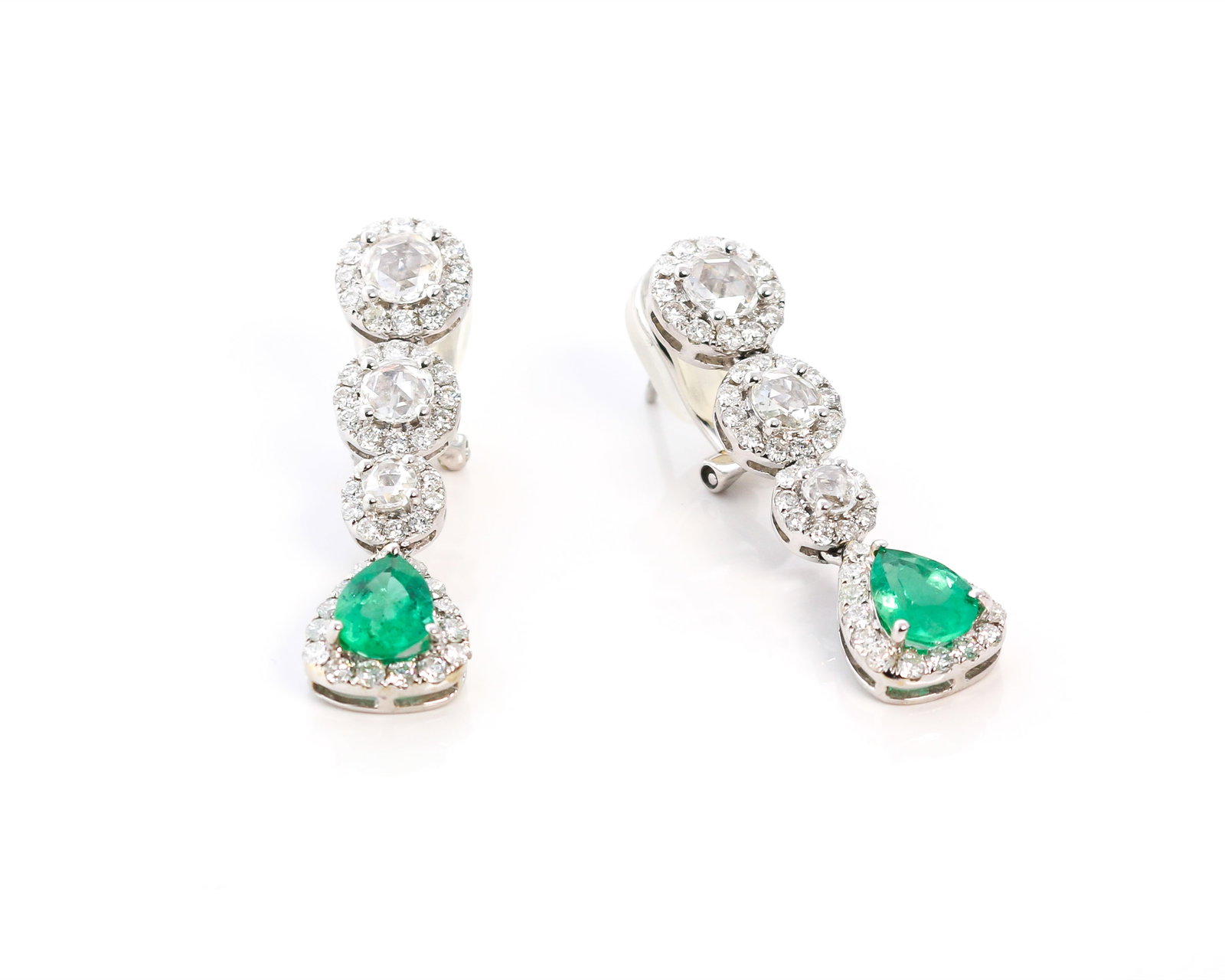 1.29ct Emerald and 2.01ctw Diamond 18K White Gold Earrings: Defining modern elegance, this stunning Halo pair of earrings featuring Emerald, White Diamond captures the essence of style. Expertly mounted in a Halo setting, the earrings are crafted in 6.1 grams 