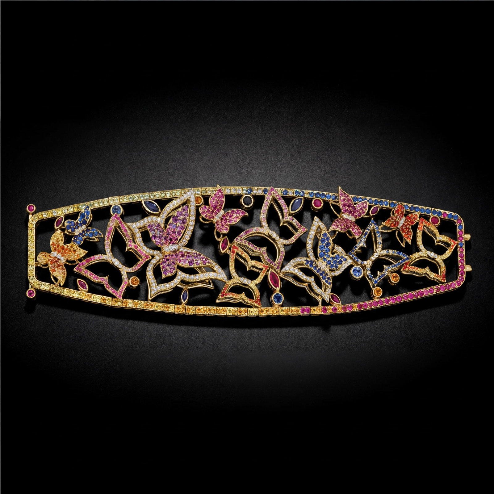 23.40 ctw Multi-gemstone and 2.65 ctw Diamond 18K Yellow Gold Bracelet: Retail Value: $69,690 Rare and radiant, this magnificent Butterfly bracelet featuring Blue Sapphire, Ruby, Pink Sapphire, Yellow Sapphire, White Diamond offers a touch of the extraordinary. Showcasing