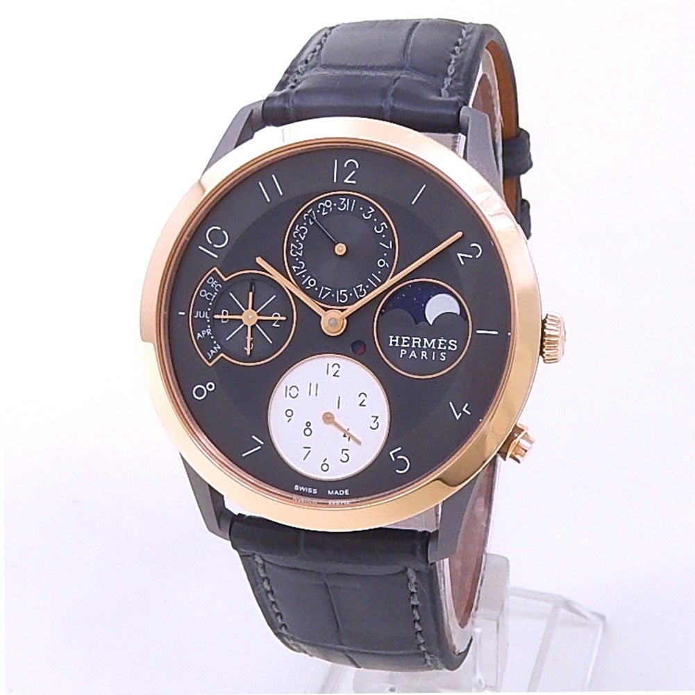 Hermes Slim d'Hermes CA3.841 Titanium & Rose Gold Grey Perpetual Calendar Dial: The unique elegance of the Hermes Slim d'Hermes, Reference CA3.841, marks a pinnacle of contemporary horological design. Crafted with a lightweight, matte-finished titanium and 18K rose gold case, thi