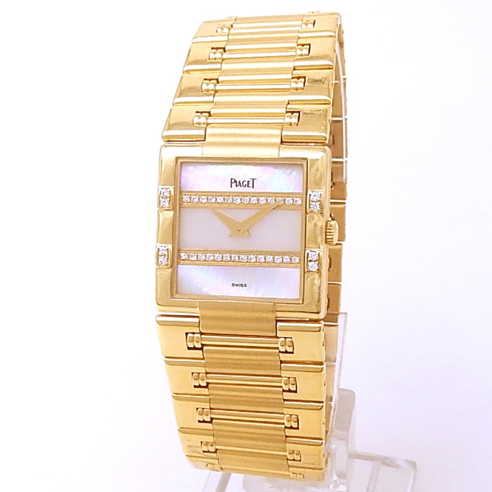 Piaget Dancer 80327 K81 18k Yellow Gold Mother of Pearl with Diamonds Dial: The Piaget Dancer, Reference 80327 K81, epitomizes the elegance and joie de vivre of the 1980s. Crafted entirely in 18k yellow gold, this ladies' timepiece features a brilliant diamond-set bezel t