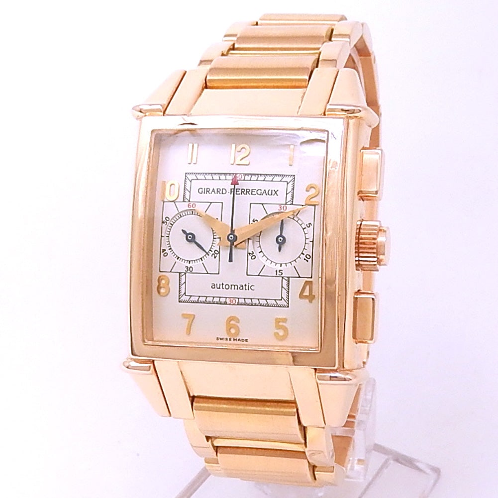 Girard-Perregaux Vintage 1945 2599 18K Rose Gold Silver Dial: The Girard-Perregaux Vintage 1945, Reference 2599, is an elegant fusion of classic vintage aesthetics and modern horological expertise. Crafted in luxurious 18k rose gold, this distinctive rectangular