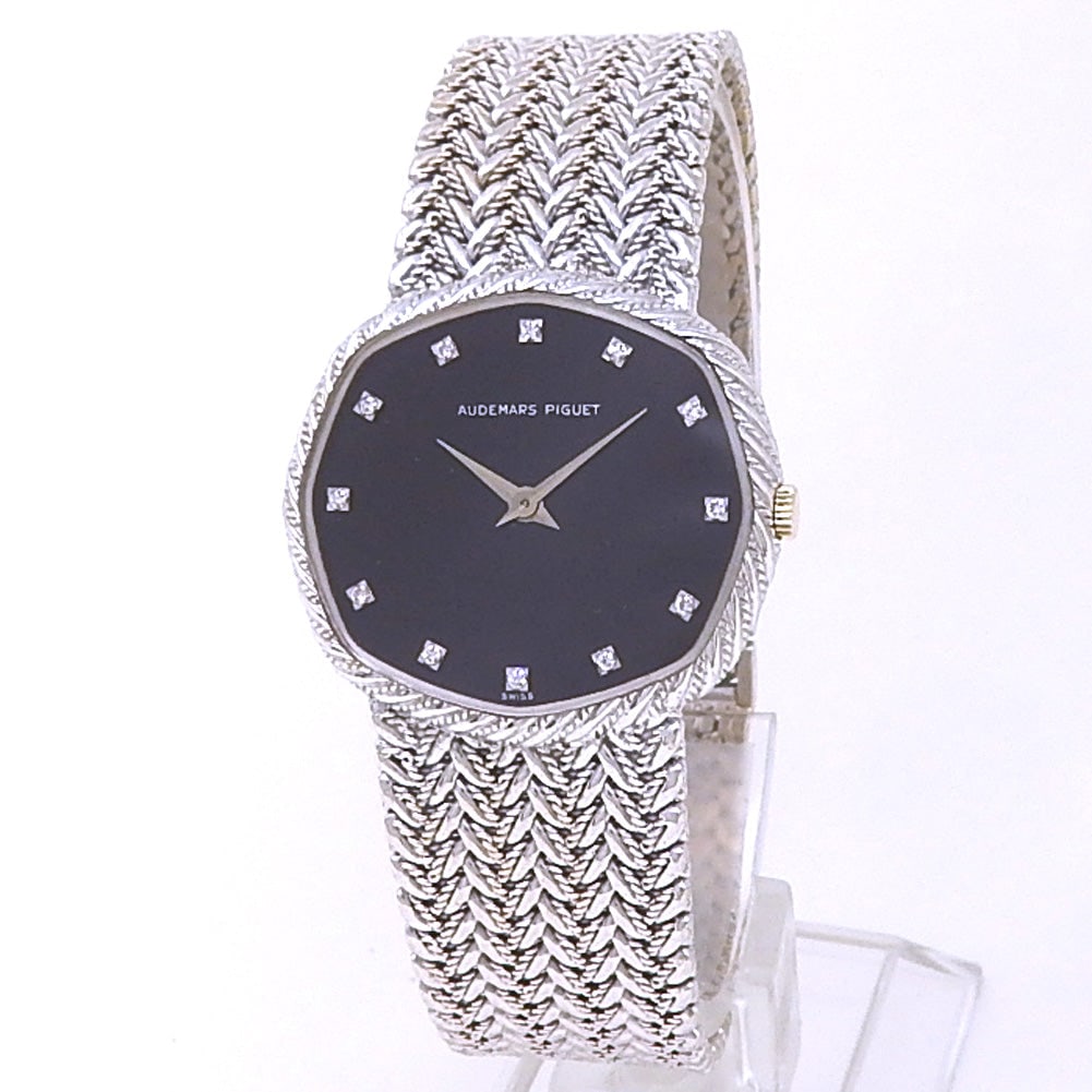 Audemars Piguet Vintage 14066BC 18k White Gold Black Diamond Dial: The Audemars Piguet Vintage, Reference 14066BC.OO.0498BC.01, is an exquisite representation of retro luxury and haute horlogerie. Crafted in lustrous 18k white gold, this ladies' timepiece is defined 