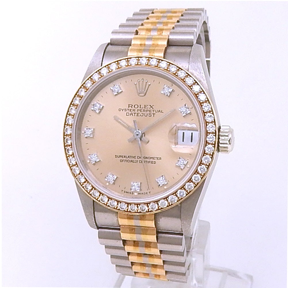 Rolex Datejust 31 68289 18k White Gold Tridor Champagne Diamond Dial: The Rolex Datejust 31, Reference 68289, is a breathtaking fusion of classic elegance and refined luxury. Crafted in 18k White Gold, this midsize timepiece features a sumptuous Champagne dial adorn
