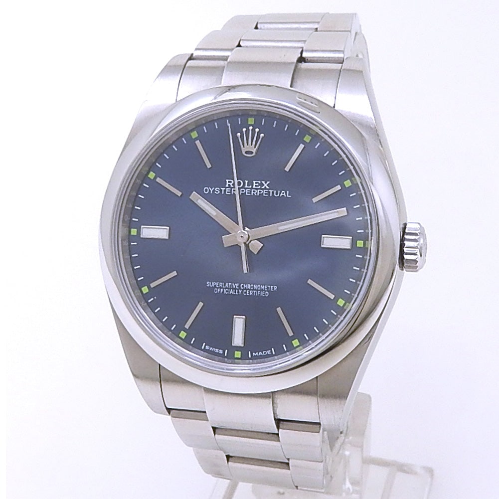 Rolex Oyster Perpetual 114300 Stainless Steel Blue Dial: The Rolex Oyster Perpetual, Reference 114300, is a masterpiece of timeless design and precision. Crafted entirely from robust Stainless Steel, this timepiece features a stunning Blue dial that rad