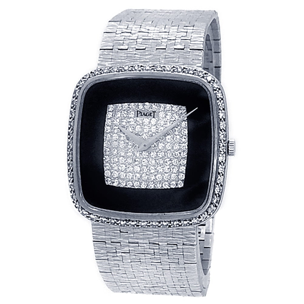 Piaget Vintage 9775 A6 18k White Gold Onyx Pave Diamond Dial: The Piaget Vintage, Reference 9775 A6, is a breathtaking paragon of high-society glamour and luxury. Exquisitely crafted in radiant 18k white gold, this elegant ladies' timepiece features a scintillat