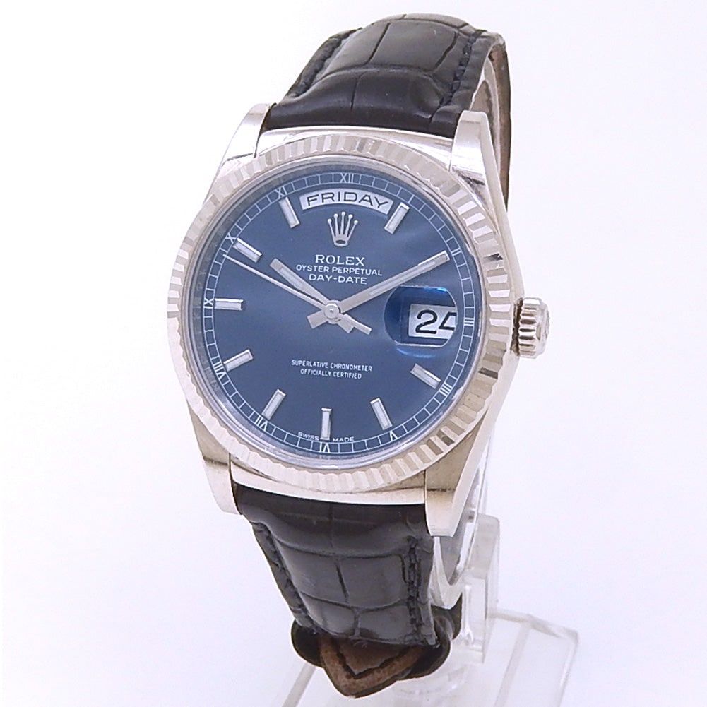 Rolex Day-Date 118139 18k White Gold Blue Dial: The Rolex Day-Date, Reference 118139, embodies timeless elegance and prestige. Crafted in 18k White Gold, this timepiece features a captivating Blue dial that exudes sophistication. The iconic day
