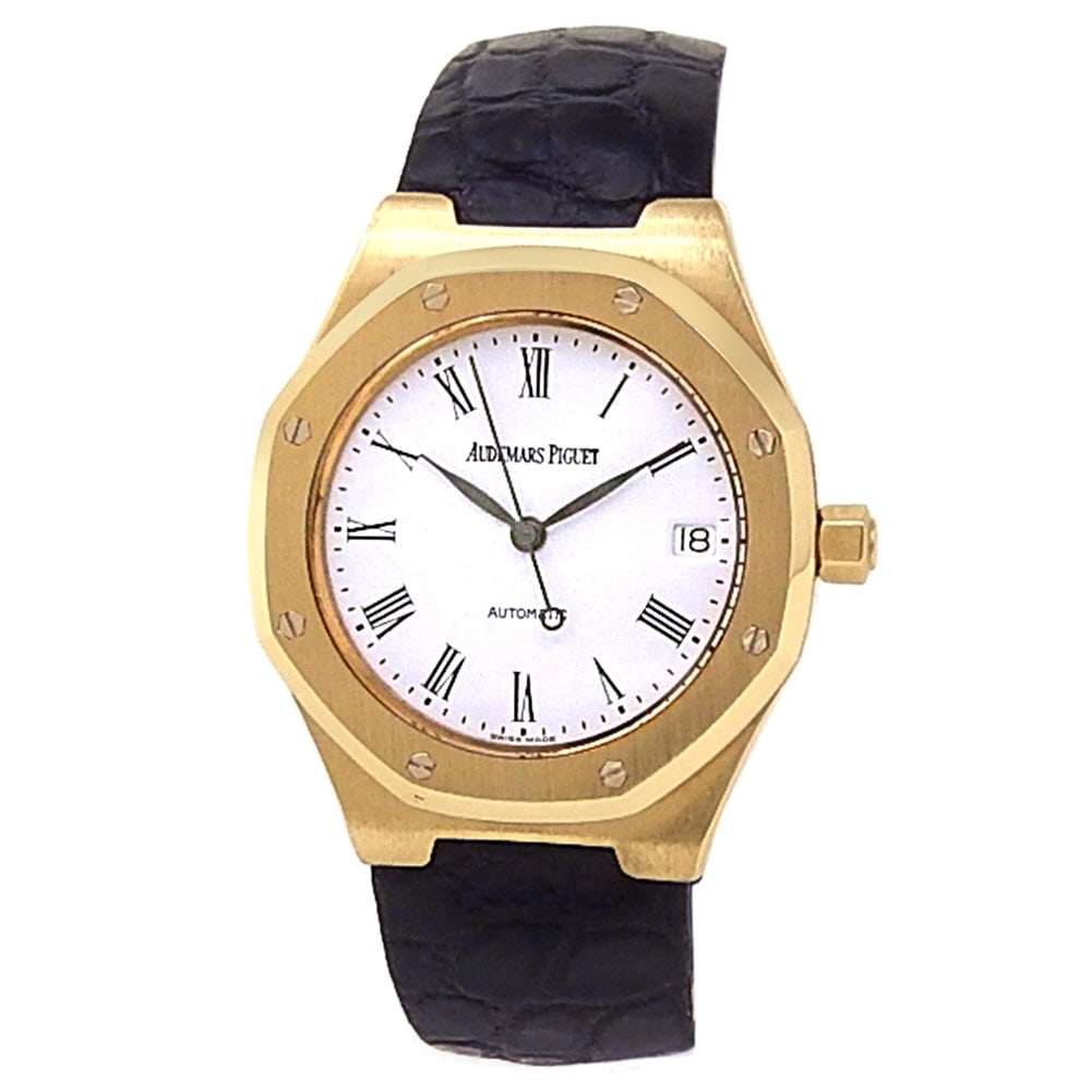 Audemars Piguet Royal Oak 18k Yellow Gold White Dial: The Audemars Piguet Royal Oak is a masterpiece of horological design and precision. Crafted in a luxurious 18k yellow gold case, this exquisite timepiece features a pristine white dial accented by