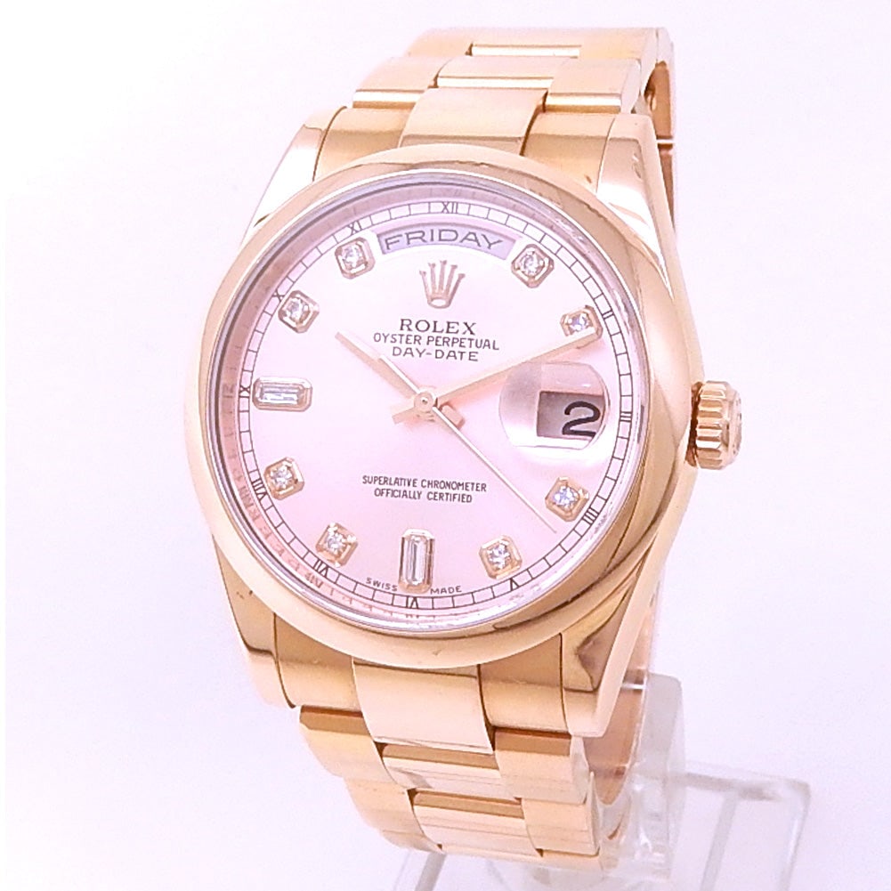 Rolex Day-Date 118205F 18k Rose Gold Pink Diamond Dial: The Rolex Day-Date, Reference 118205F, is an iconic statement of horological prestige and luxury. Beautifully fashioned in lustrous 18k Rose Gold, this timepiece is distinguished by its Pink dial
