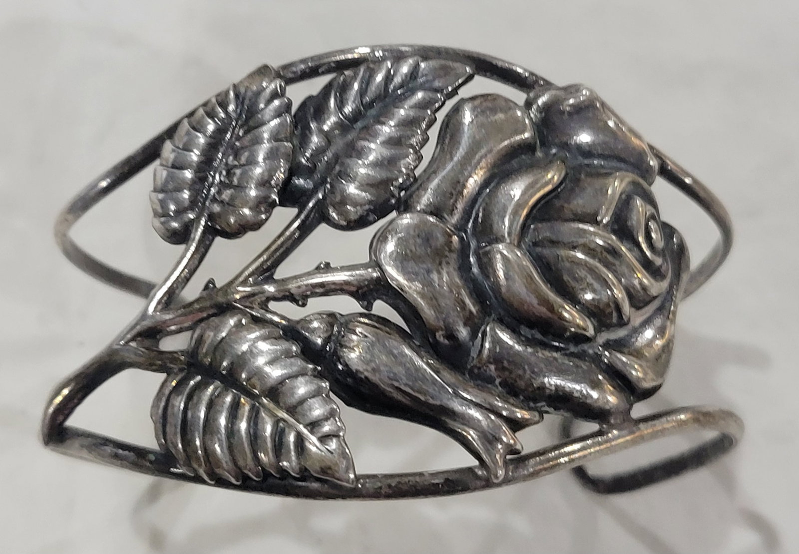 Sterling Silver cuff bracelet with rose and leaf floral design: 1940's Danecraft Sterling Silver cuff bracelet with ornate rose and leaf floral design - Stamped Danecroft