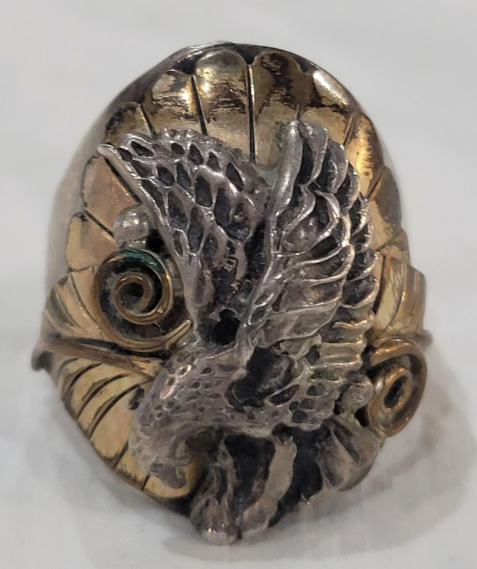 Vintage Handcrafted Navajo eagle ring: Vintage Handcrafted Navajo eagle ring featuring a silver eagle atop a gold-filled background of leaves and scrollwork - Size 10.5