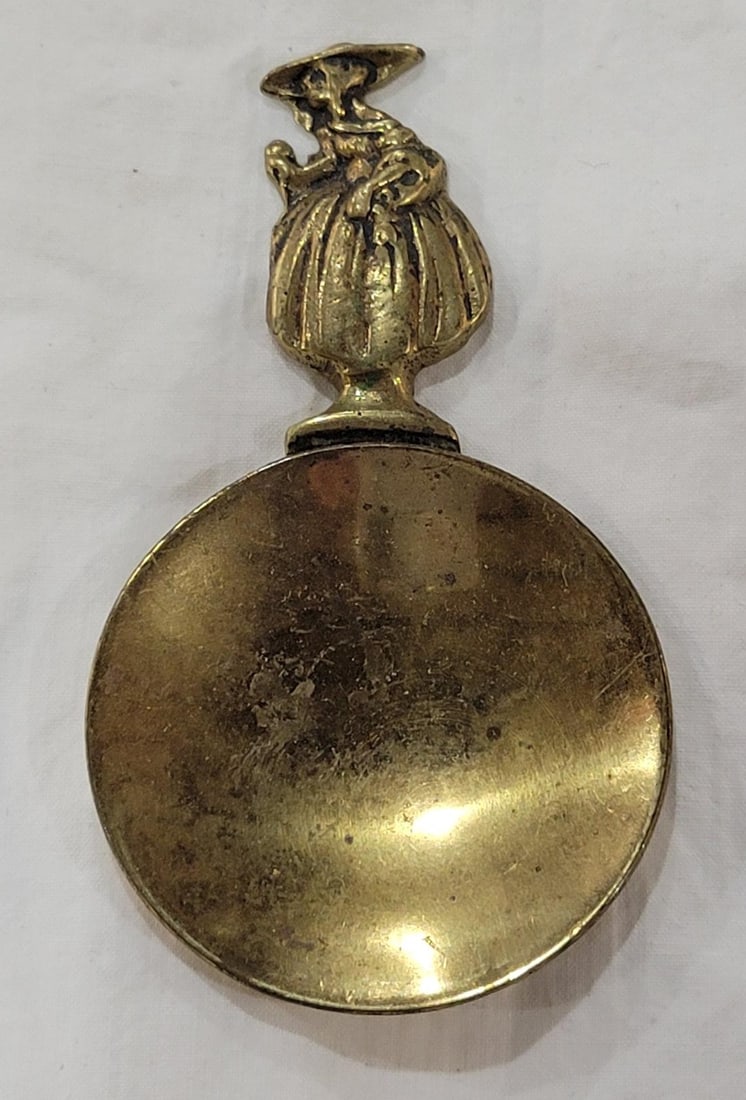 Vintage solid brass tea caddy spoon rest - tea bag holder: Vintage solid brass tea caddy spoon rest - tea bag holder featuring a crinoline lady figure on the handle - Manufactured: Peerage, England 1920's-1940's Stamped Made in England