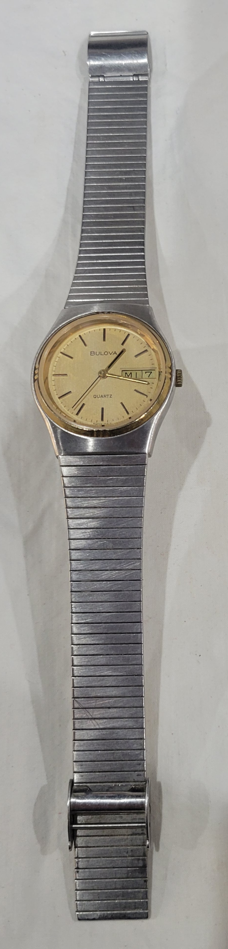 Vintage Bulova Men's Quartz Watch: Two-tone Silver and gold case featuring a day-date indicator Model Swiss 7159 yr. 1977