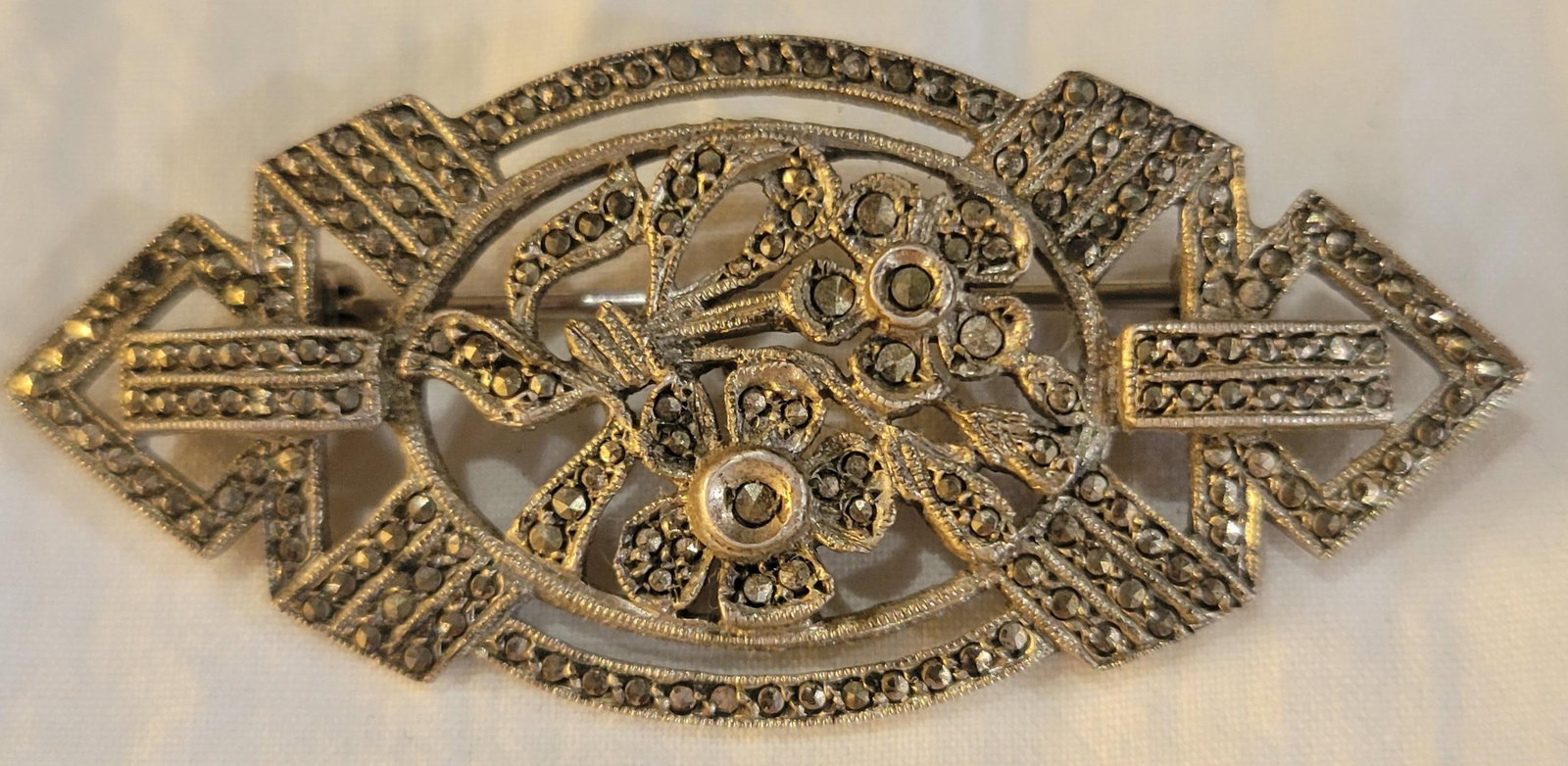 Vintage Marcasite Sterling Silver Brooch Pin: Art Deco Marcasite Sterling Silver geometric shaped brooch pin featuring floral elements