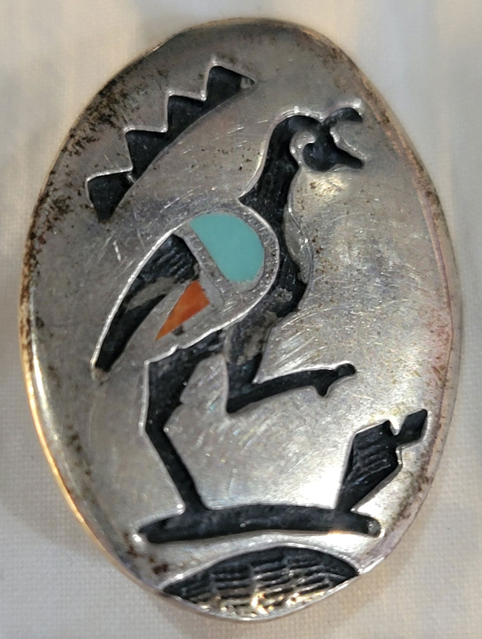 Vintage Navajo Sterling Silver pin featuring Kokopelli bird figure: Sterling Silver with inlay of turquiose and coral