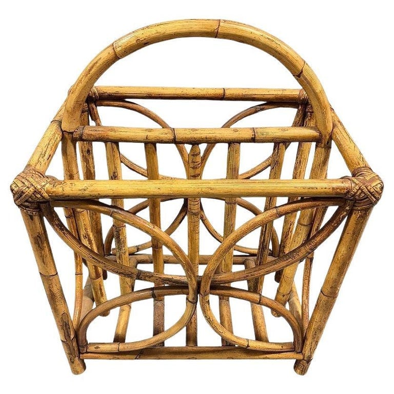 Mid-century Rattan "Butterfly" Magazine Rack with Handle: This beautifully restored rattan Magazine Rack blends style and vintage charm with modern comfort. The magazine Rack features a butterfly-inspired design along each side made from small pole rattan an