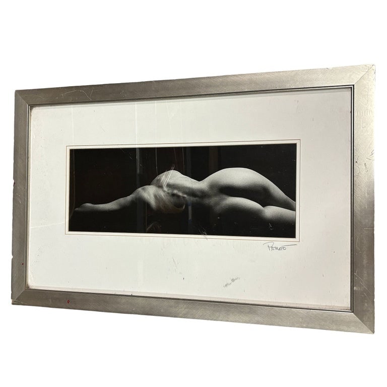 Framed Black and White Photography Print of Nude Figure: Striking black and white photographic print of a nude figure, elegantly framed. The composition highlights the interplay of light and shadow, celebrating the human form with a timeless, minimalist aes