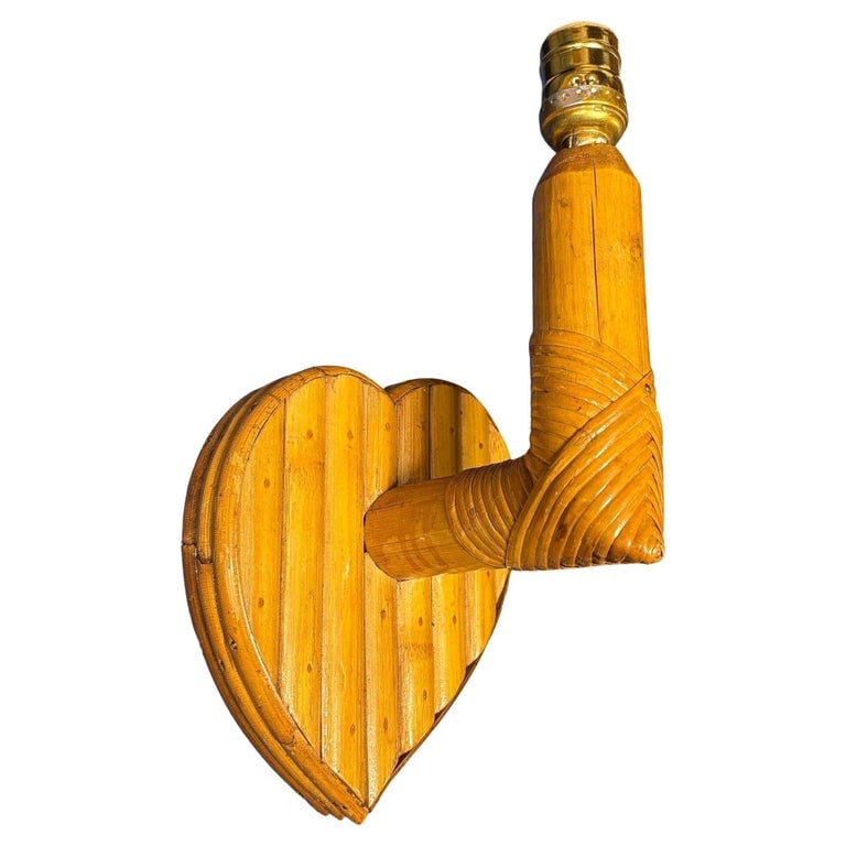 Bespoke Mid-century Split Rattan Heart Shaped Wall Sconce: This beautifully restored Custom-made bespoke rattan heart-shaped sconce exudes warmth, blending style and vintage charm with modern comfort. It features a heart-shaped wall made from split rattan mou