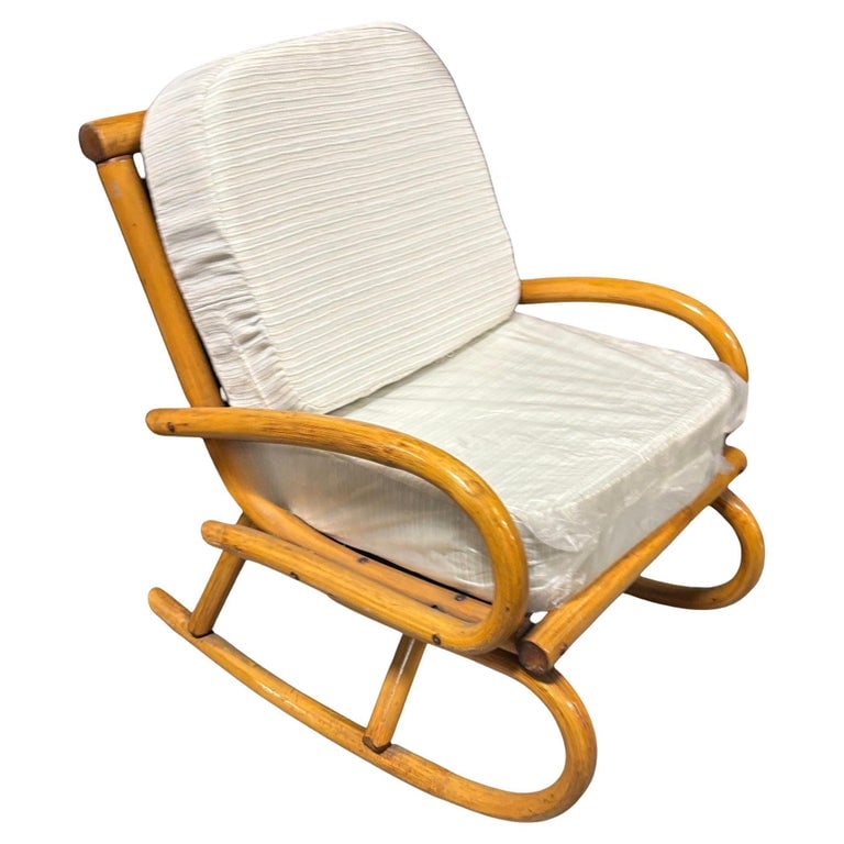 Restored Mid-century Frankl Style Child's Pole Rattan Bent Arm Rocking Chair: This beautifully restored child-size rattan rocking chair combines vintage charm with sturdy craftsmanship. The chair is made from single-strand round bent rattan arms and legs featuring large loops f