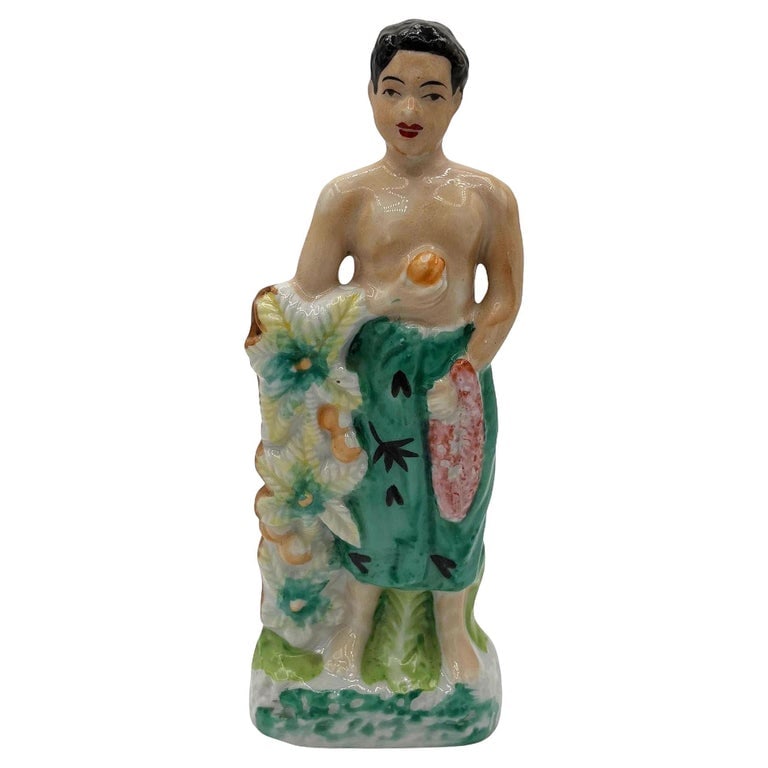 Mid-century Native Boy w/ Fruit Offering & Flowers Ceramic Miniture Figurine: Original post-war ceramic Hawaiian native boy with fruit offering & flowers made from lightweight plaster and painted in vibrant tropical colors. It depicts a young Native Hawaiian boy with a Lei in