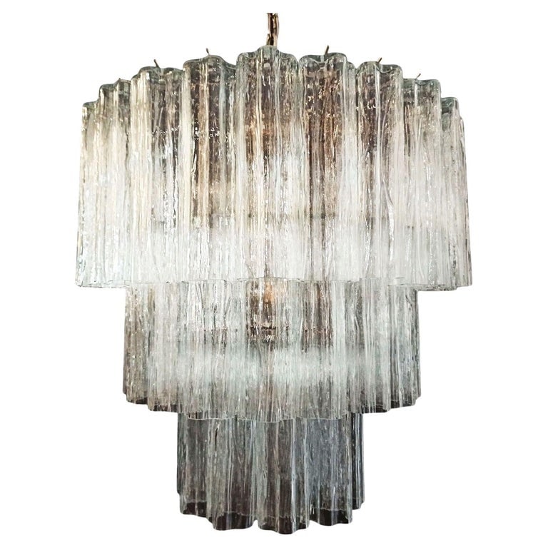 Murano Glass Tronchi Pendant Chandelier by Venini: Made in Italy, this gorgeous round chandelier features a brass frame and three tiers of textured glass pendants, known as tronchi by Venini. The light glistens through the glass pendants, which are