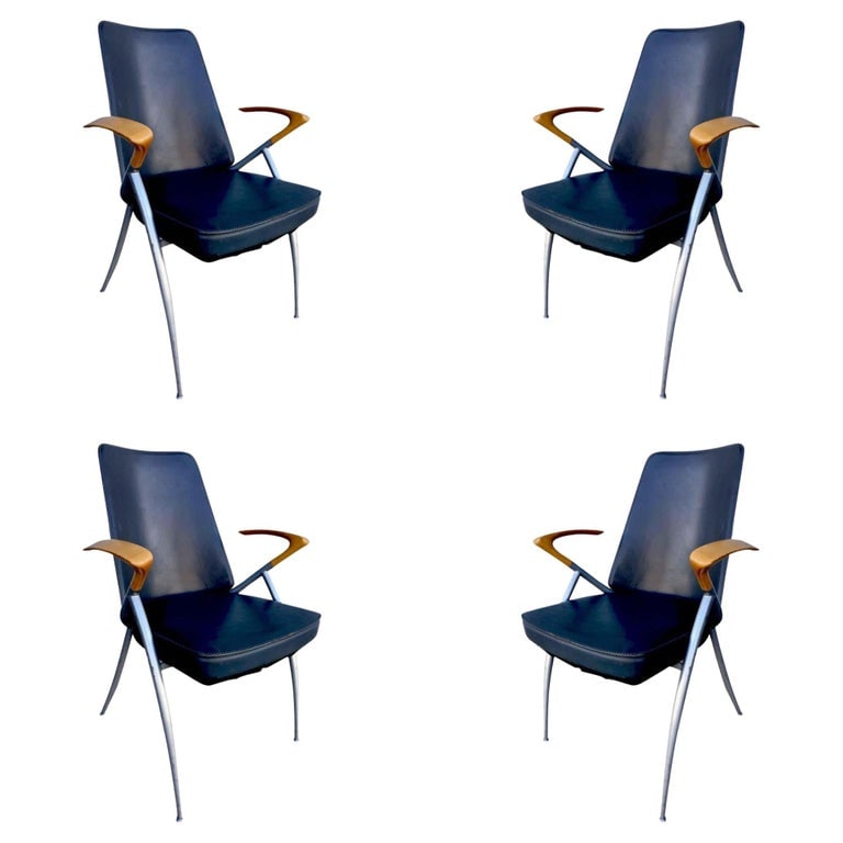 1980's Paul Tuttle Style Post Modernist Dining Chair Set of four: Modernist leather office chair (can be used as dining chair) with silver powder coat base and unique floating cherry oak wing back armrest.