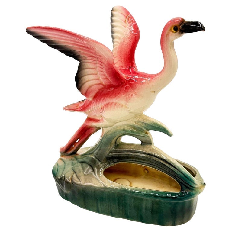 Mid-century California Pottery Ceramic Pink Open Wing Flamingo Table Planter: Mid-century pink and green ceramic open-wing flamingo tabletop California art pottery planter. The planter features a beautifully detailed pink flamingo flying over a small pond. It comes in a gloss