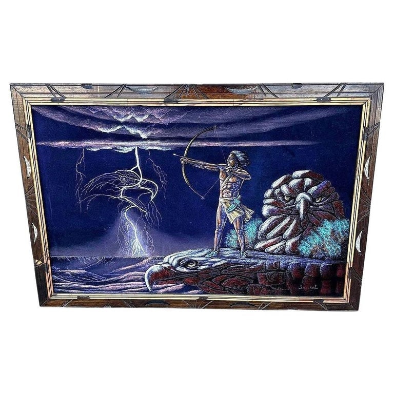 Mid-century Native Archer & Eagle Oil Velvet in Carved Frame by Ernesto Sanchez: This striking mid-century velvet painting depicts a Native American warrior archer and the American Bald Eagle spirit depicted in the Southwest Desert with lighting in the background. The oil