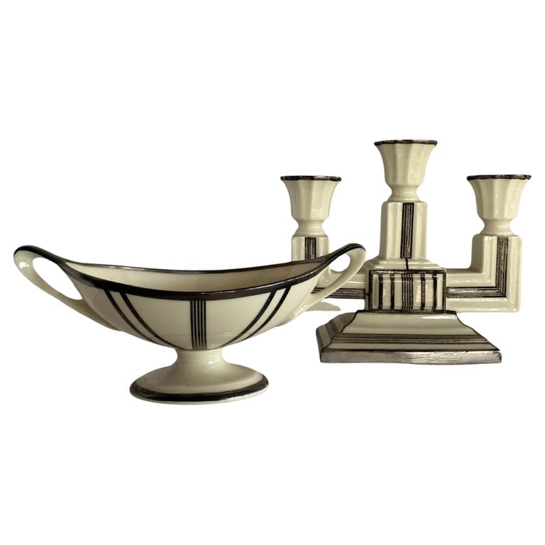 Two-Piece Sugar Bowl and Candelabra with Sterling Silver Overlay by Lenox: Stepped Art Deco ceramic candelabra and matching sugar bowl with sterling silver overlay by Lenox.Candle opera: height: 6.5 in. width: 7.5 in. depth: 3 in.Sugar bowl: height: 3.5 in. width: 8.5 in. de