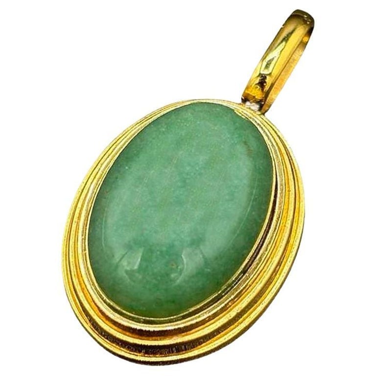 Large 14k Gold Stepped Natural Aventurine Oval Pendent: This Art Deco-style pendant embodies elegance with its luxurious aventurine centerpiece and radiant gold accents. Designed with a classic stepped pattern, the pendant captures the geometric sophistica