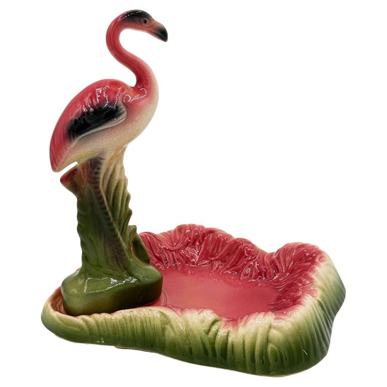 Mid Century Pink and Green Flamingo Ceramic Figurine in Flamingo Pool Ring Tray: Mid-century pink and green flamingo ceramic figurine in a flamingo pool tray decorative bowl, commonly used as a ring jewelry tray. The set features a detailed pink flamingo among lush green leaves, a