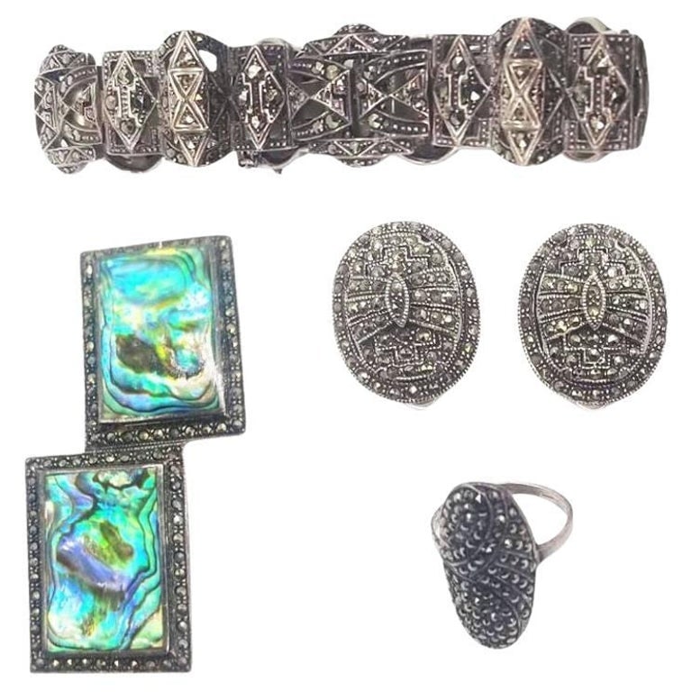 Sterling Silver French Paste Marcasite Jewelry Set, Brooch, Bracelet, Earrings: This Mid-Century and Art Deco Estate Jewelry Marcasite Set is a dazzling ensemble featuring a brooch, bracelet, and clip-on earrings. Crafted with intricate marcasite detailing set in timeless designs