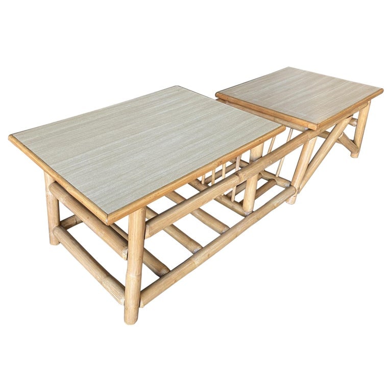 Restored Asymmetric Two-Tier Rattan Coffee Table with Architectural Base: Paul T. Frankl inspired asymmetric two-tier rattan coffee table with an architectural base. The table features a unique split-level design with two different height tabletops and a magazine rack locat