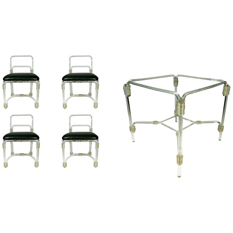 Grosfeld Lucite Dining Table with Four Chairs, circa 1940s: Elegant 1940s Lucite dining table with four matching chairs by Grosfeld House.This 1940s dining set features a table framed in tubular Lucite with an inset glass top and embellished with elegant acryl