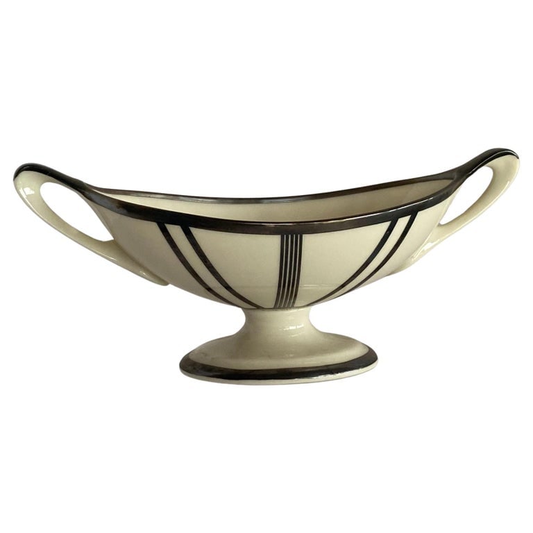 Stepped Art Deco Candelabra with Sterling Silver Overlay by Lenox: This exquisite sugar bowl, crafted circa 1930, showcases the timeless elegance of Art Deco design with a distinctive stepped silhouette. Manufactured by Lenox, renowned for its fine ceramics, this pie