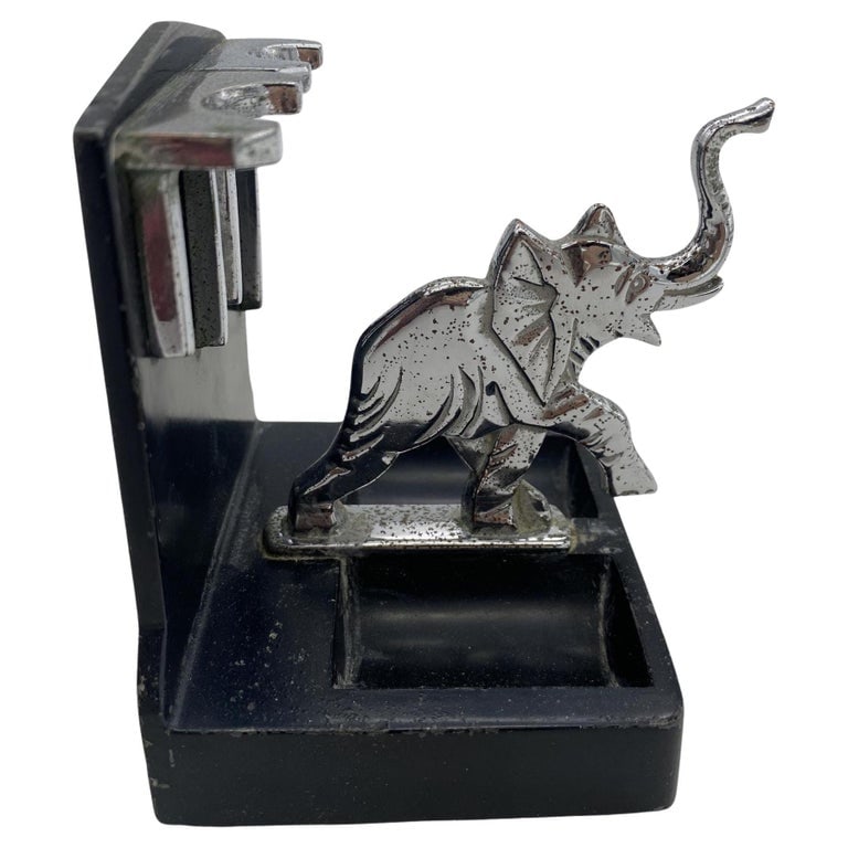 Rare Chrome Art Deco Elephant Pipe Holder by Ronson: A ronson elephant two pipe holder with a chrome elephant and accents with a black powder coat base. It is listed in advertisement "Ronson - the World's Greatest Lighter" as "Extremely Rare" and first