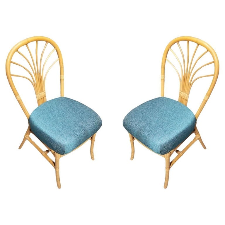 Restored Rattan Fan Back Dining Chairs, Pair: This beautifully restored Paul Frankl-inspired pair of 1980s postmodern fan back rattan dining or accent side chairs in teal blue seat cushions.Circa 1980sWe only purchase and sell only the best and f