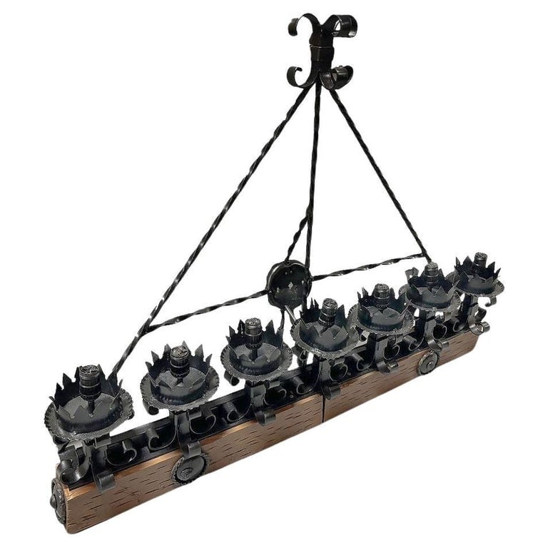 Spanish Revival Wrought Iron 7-Light Wood Beam Grand Wall Sconce, 2 Available: This Spanish Revival/ Medieval revival-style wrought Iron Seven-Light wood beam wall sconce showcases an elegant Fleur de Lys motif, exuding historical charm and robust craftsmanship. The wall sconce,