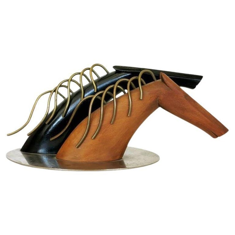 Art Deco Hagenauer Style Carved Horses by Sier Kunst: Art Deco Clydesdale wood sculpture featuring a pair of hand carved race horses with undulating bronze manes mounted to a chrome base, featuring one horse finished in a naturally tone wood and one blac