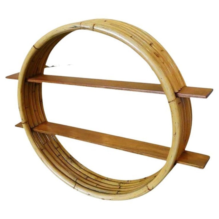 Restored Midcentury Circular Rattan Wall Shelf with Mahogany Slats: Circular rattan wall self, circa 1950. This rare rattan wall shelf features unique five strand stack rattan frame made with cut-out sections that hold two mahogany shelves. 1960s, United StatesWe
