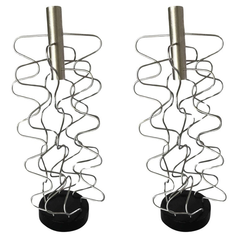 Custom Made Wire Art Candlestick Holder, Pair: Pair of custom Made Wire Art candlestick holders made of 8 sculptural wire pieces fixed to a black base with chrome holder along the top.