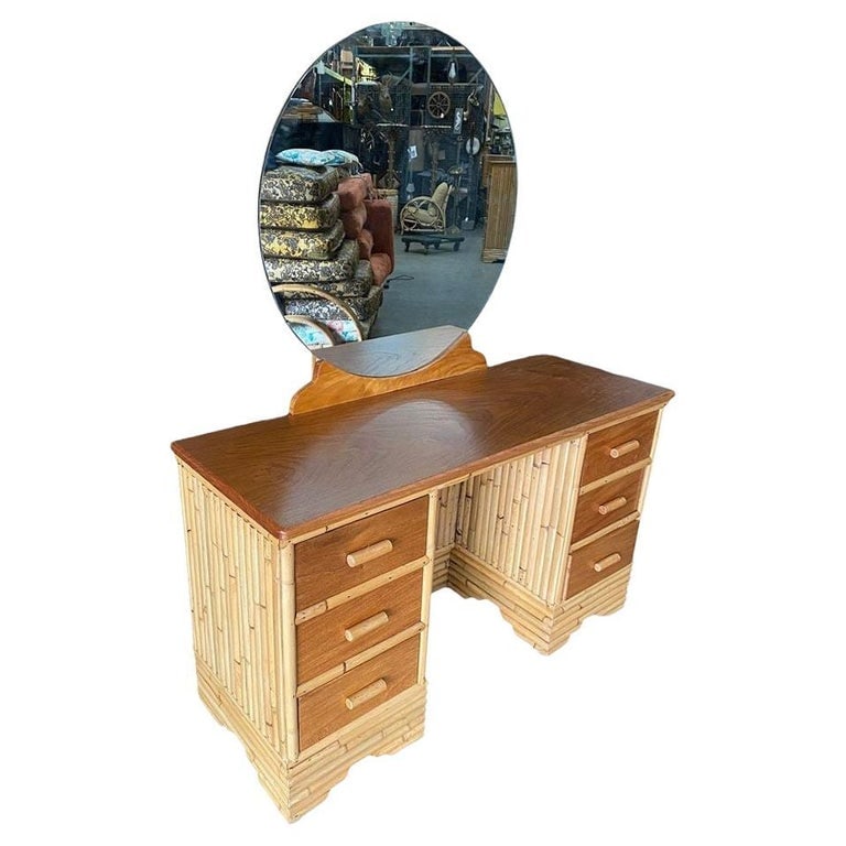 Restored Early Mid-century Stacked Rattan & Mahogany Vanity w/ Round Mirror: This beautifully restored Paul Frankl-inspired rattan vertically staked rattan vanity blends style vintage charm with modern comfort. It features a Filipino mahogany table top, drawer fronts, and a ro