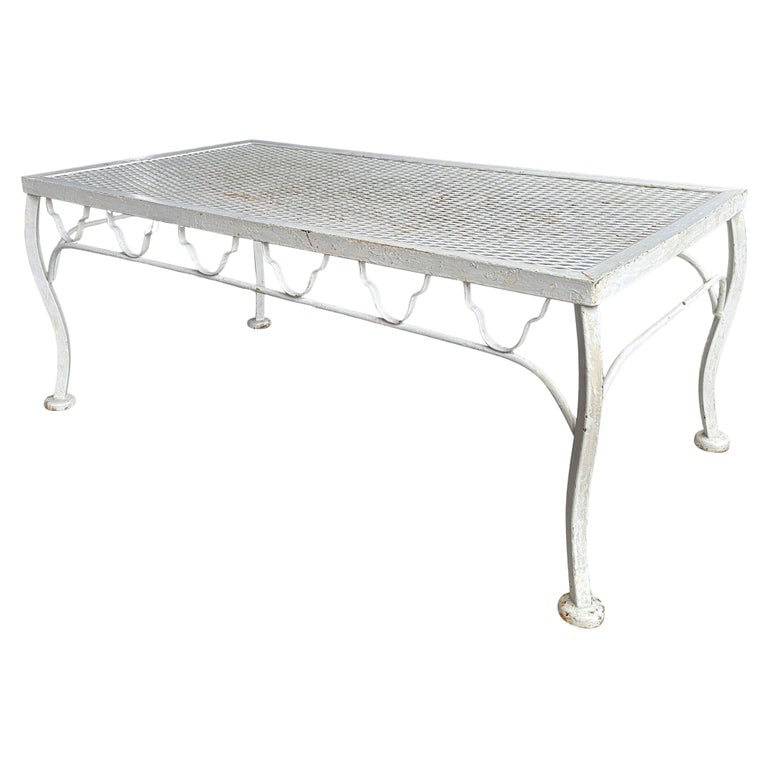 Mid-century Wrought Iron Outdoor/ Patio Low Mesh Coffee Table by Woodard: Mid-century wrought iron and steel mesh low coffee table for patio and outdoor use by Woodard. The coffee table features a trellis pattern on each side of the table and curved legs. Its low profile an
